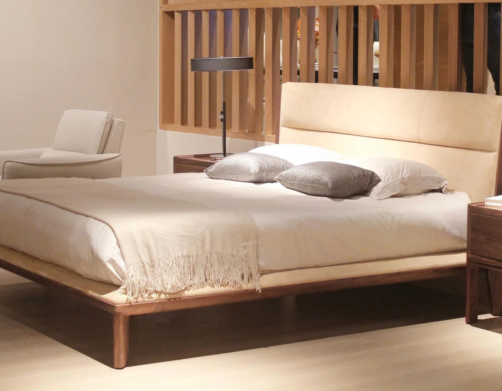 Junzi Collection walnut-framed bed in a calm bedroom