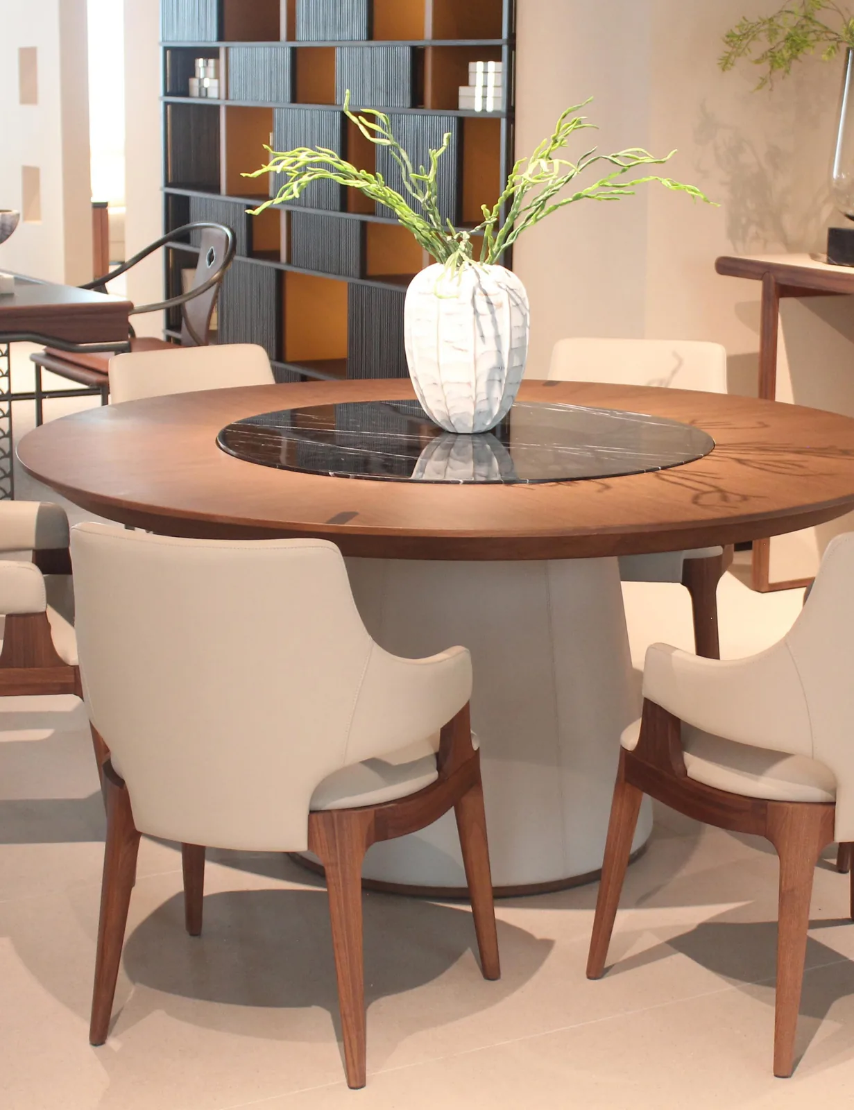 Junzi Collection round walnut dining table with upholstered chairs