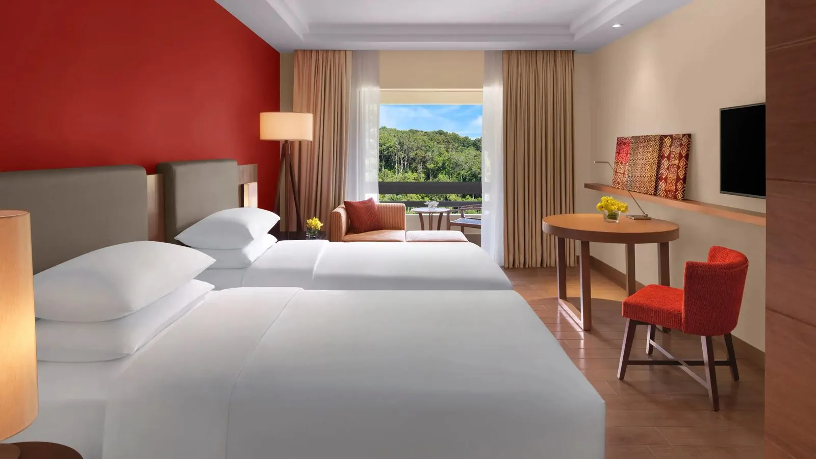 Hotel room with twin beds and red accent wall