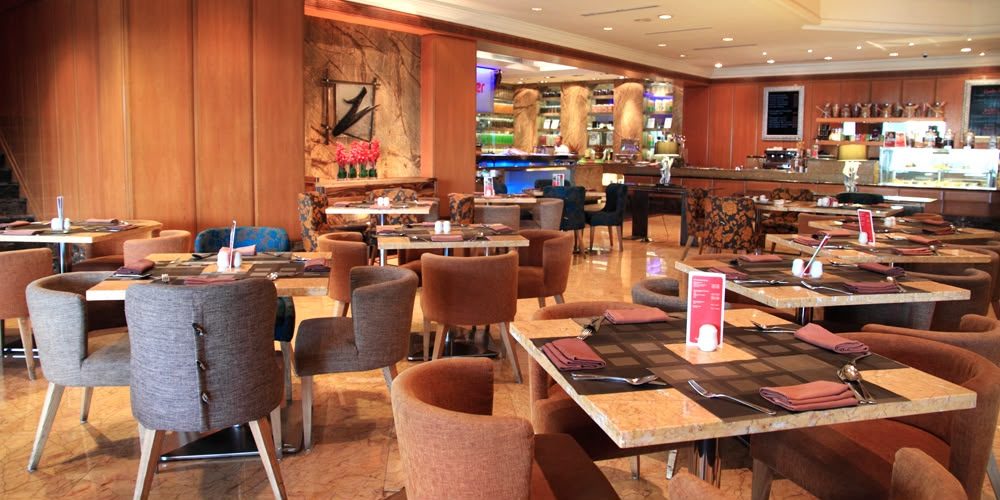 Hotel restaurant dining area with marble-top tables