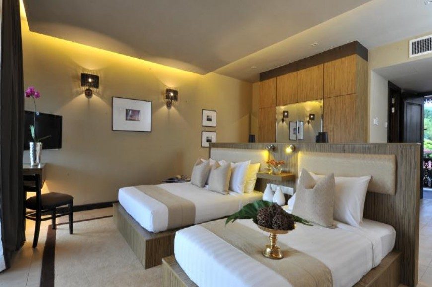 Hotel guest room with twin beds and warm lighting