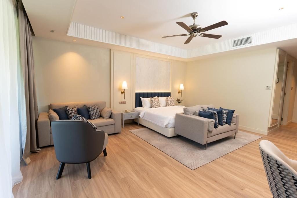 Hotel living area with grey sofas and ceiling fan