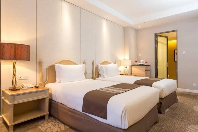 Hotel guest room with twin beds and neutral decor