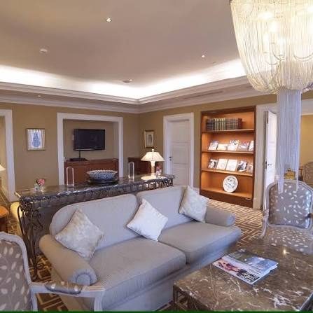 Hotel suite living room with chandelier and bookshelf